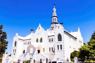White Cape Dutch-style Dutch Reformed Church building with clock tower in Swellendam, Western Cape, South Africa.