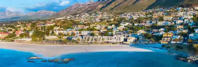 Aerial view of Gordon's Bay, where white-sand beaches and turquoise waters meet the foothills of the Hottentots Holland Mountains along False Bay.
