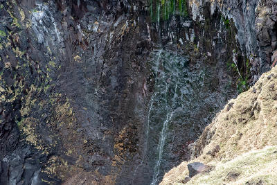 Furepe Falls flowing down a steep rock face in Shiretoko National Park, Hokkaido