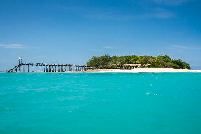 Prison Island near Stone Town, Zanzibar, with white sandy beaches, turquoise Indian Ocean waters, and a wooden jetty.