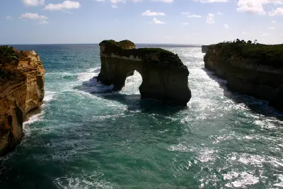 London Arch limestone formation surrounded by cliffs and ocean in Port Campbell National Park.