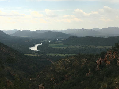 View from a Vredefort Dome hiking trail overlooking the Vaal River valley, rolling hills and layered ridges in the UNESCO World Heritage Site, South Africa.