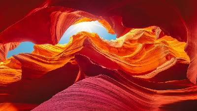 Abstract sandstone formations inside Antelope Canyon showing flowing layers and reflected light