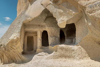 Ancient cave dwelling carved into soft volcanic tuff rock in Göreme, Cappadocia, Turkey.