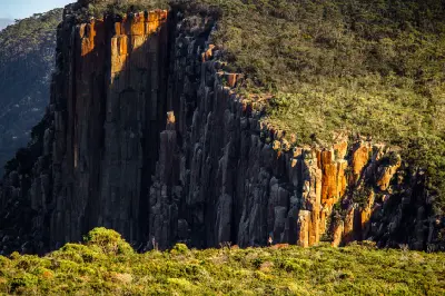 Winter sunlight catching the vertical dolerite cliffs at Cape Hauy, Tasmania.