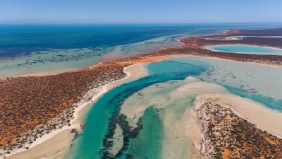 Aerial view of turquoise channels, sandbars and red coastal landscapes in Shark Bay.