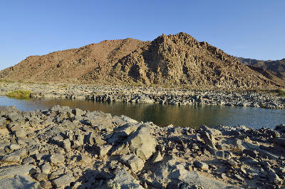 The Orange River winding through rocky desert mountains in the Richtersveld along the South Africa–Namibia border.
