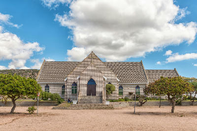 The Dutch Reformed Church stands at the heart of St Helena Bay, framed by coastal vegetation and granite hills that characterise the landscapes of South Africa’s West Coast.