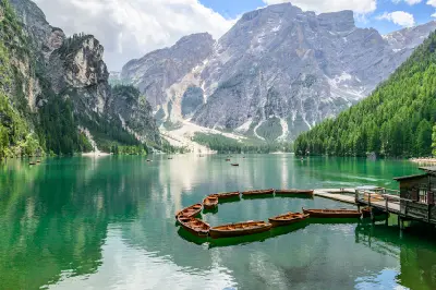 Wooden boats and jetty on Lago di Braies in the Dolomites, Italy.