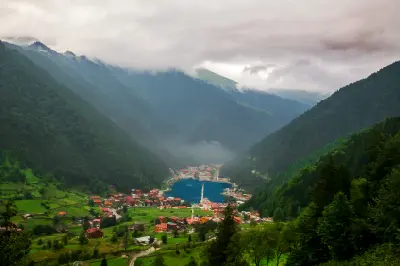 Elevated view of Uzungöl Lake and village nestled between steep green mountains in Trabzon, Turkey.