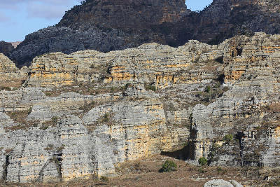 Layered sandstone canyon walls and eroded rock formations in Isalo Canyons, Madagascar