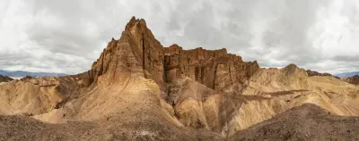 Red Cathedral rock formation rising above badlands at Zabriskie Point Death Valley California