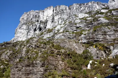 Steep quartzite cliffs and rocky slopes of Frenchmans Cap in western Tasmania.