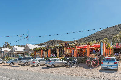 Street view of the Country Pumpkin restaurant and roadside buildings in Barrydale on Route 62 in the Western Cape, South Africa.