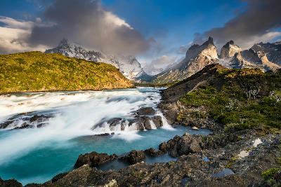 Salto Grande waterfall with turquoise glacial water and mountains in Torres del Paine National Park, Patagonia, Chile.