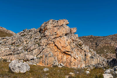 Layered sandstone cliffs and rock formations surrounding the Maltese Cross area in the Cederberg Mountains, Western Cape, South Africa.