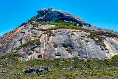 Steep granite face and summit of Frenchman Peak in Cape Le Grand National Park, Western Australia.