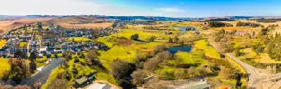 Aerial view of Nottingham Road in the KwaZulu-Natal Midlands, showing the village, surrounding farmland, dams and rolling countryside.