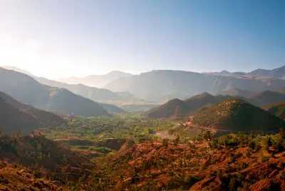 Layered mountain ridges and green valley landscapes in the Atlas Mountains near Ourika Valley, Morocco.