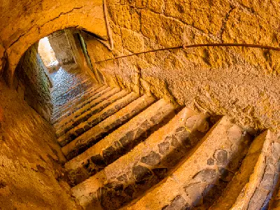 Stone stairway passage in the medieval village of Sovana in the Maremma region of Tuscany, Italy.