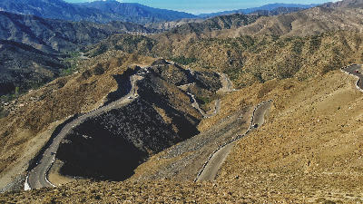 Hairpin mountain road and rugged High Atlas landscape at Tizi n'Tichka Pass in Morocco.