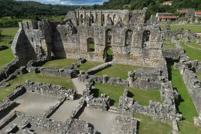 Aerial view of medieval stone walls, doorways and excavated monastery foundations at Rievaulx Abbey in North Yorkshire.