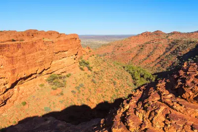 View across the red sandstone cliffs and rugged desert landscape of Kings Canyon in Watarrka National Park, Australia.