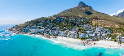 Aerial photograph of Clifton Beach showing white sand, clear turquoise water and luxury apartments built along the Atlantic Seaboard slopes below Lion’s Head in Cape Town.