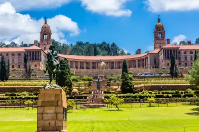 The Union Buildings in Pretoria overlook terraced gardens, with the Nelson Mandela statue and historic grounds visible in the foreground.