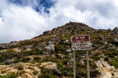Mountain summit sign at Die Top on Swartberg Pass in the rocky Swartberg Mountains of the Klein Karoo in South Africa.