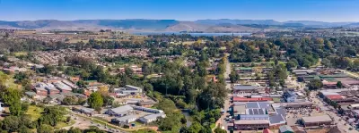 Aerial panorama of Howick showing the town centre, surrounding suburbs and Midmar Dam in the KwaZulu-Natal Midlands.