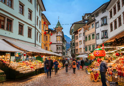 Typical street in Bolzano with Christmas decorations, showing Alpine-style buildings in South Tyrol, Italy.