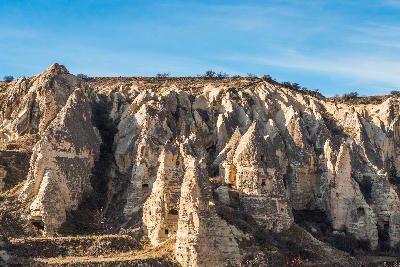 Rock-cut churches and ancient cave dwellings carved into the volcanic cliffs at Göreme Open Air Museum in Cappadocia, Turkey.
