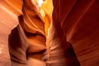 Interior of Upper Antelope Canyon in Page, Arizona showing narrow slot canyon walls with smooth layered sandstone and light entering from above.