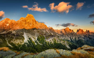 Cimon delle Pala mountain above Passo Rolle with red clouds at sunset