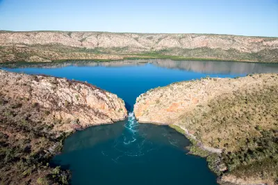Aerial view of turbulent tidal water surging through a narrow gap in the McLarty Range at Horizontal Falls.