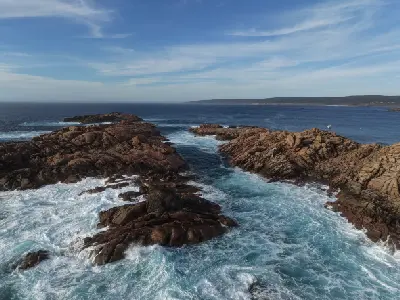 Aerial view of turquoise ocean water surging through the granite channels of Canal Rocks on Western Australia’s Margaret River coast.