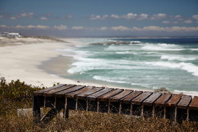 Wooden boardwalk above the white sands and Atlantic surf of Sixteen Mile Beach near Yzerfontein on South Africa's West Coast.