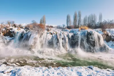 Ice-covered cascades of Muradiye Waterfall flowing through a snowy winter landscape in Van Province, Turkey.