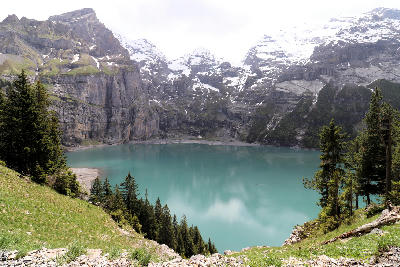 Oeschinen Lake, cradled in the heart of the Swiss Alps, is a stunning alpine jewel surrounded by towering, snow-capped mountains