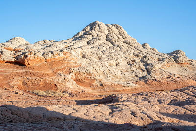 Cauliflower-like sandstone formations at White Pocket in northern Arizona with rounded white and orange rock textures.
