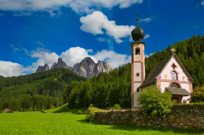 St. Johann in Ranui Church with the Odle mountains in Val di Funes, South Tyrol, Italy.