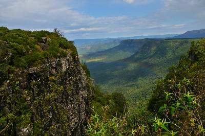 Rocky escarpment cliffs and forested valleys seen from God's Window near Graskop in Mpumalanga, South Africa.