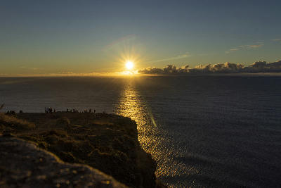 Sunset over the Atlantic Ocean seen from Miradouro do Farol da Ponta do Pargo viewpoint on the western cliffs of Madeira, Portugal.