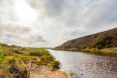 Scenic view of the Breede River winding between low hills and natural vegetation near Swellendam in South Africa.