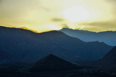 Sunset silhouette over mountain ridges in Aït Bouguemez Valley, Morocco
