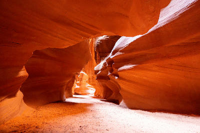 Narrow sandstone passage inside Antelope Canyon with curved walls and soft reflected light, Page, Arizona, USA