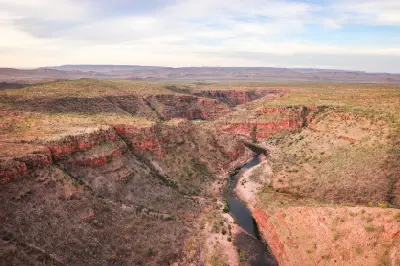 Aerial view of a winding river cutting through rugged red sandstone gorges and vast open country near El Questro in the East Kimberley.