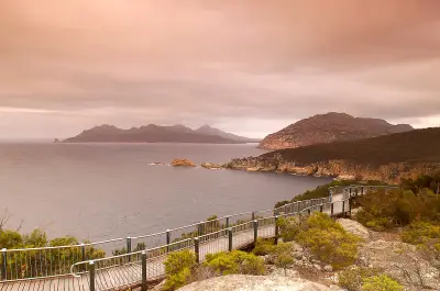 Elevated boardwalk at Cape Tourville overlooking granite headlands and the Tasman Sea in Freycinet National Park, Tasmania.
