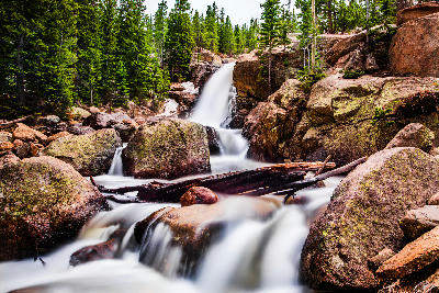 Alberta Falls waterfall flowing over rocks in Rocky Mountain National Park, Colorado.